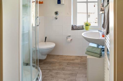a bathroom with a toilet and a sink at Wohnung 4 in Wallhausen