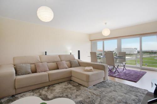 a living room with a couch and a table at A O - Apart Passarelle in Peniche