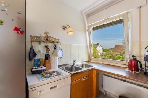 a small kitchen with a sink and a window at Ferienwohnung Oberamsel in Marburg an der Lahn