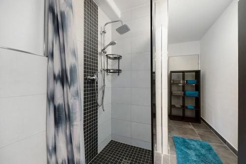 a bathroom with a shower with a blue rug at Fewo Nele in Gries