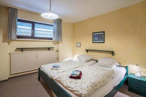 a bedroom with a bed with a tray on it at Terrassenpark Apartment 160 in Schonach
