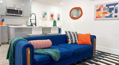 a blue couch with colorful pillows in a living room at After Hours - Wilton Drive and Jacuzzi in Fort Lauderdale
