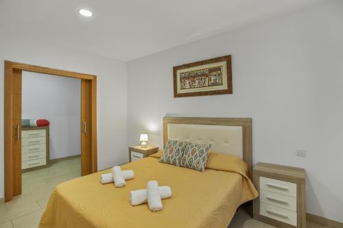 a bedroom with two beds and a mirror at Edificio Bentejui 1 in Las Palmas de Gran Canaria