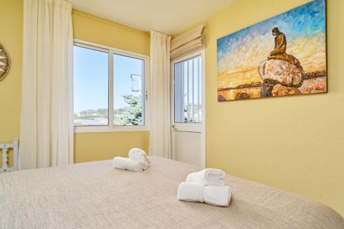 a bedroom with a bed with two towels on it at Vakantiewoning Torrox Park 300 in Torrox