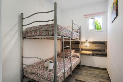 a bunk bed room with two bunk beds at Casa Mirajanda in Vejer de la Frontera