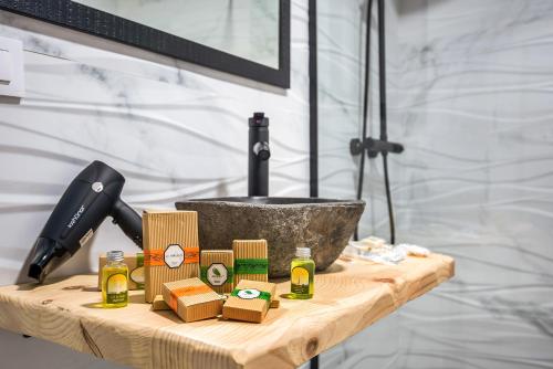 a wooden table with products on it in a bathroom at Casa Mirajanda in Vejer de la Frontera