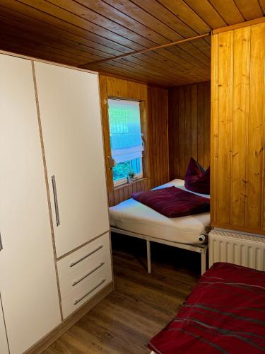 a small room with a bed and a window at Haus Waldidyll am Briesensee in Neu Zauche
