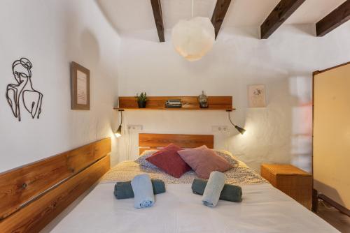a bedroom with a bed with two pillows on it at Can Vital 1 in Illes Balears