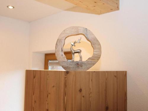 a sculpture of a deer in a mirror on a wall at Apartment Melissa in Zellberg