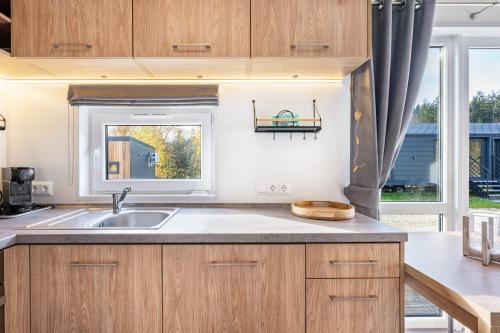 a kitchen with a sink and a window at Side-by-Side Tiny Houses in Untergriesbach