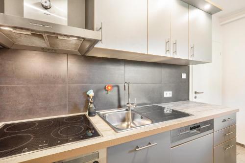 a kitchen with a sink and a stove at Fewo Auszeit zum Anspel in Medebach