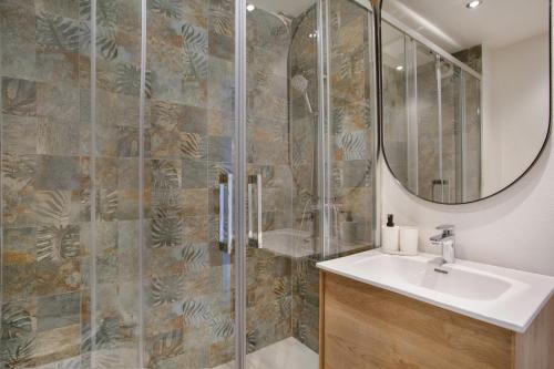 a bathroom with a shower with a sink and a mirror at Morada Ribes in Costa de Antigua