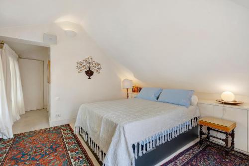 a bedroom with a bed with blue pillows on it at Attico Palazzo Giustiniani in Genoa