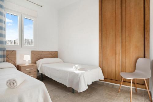 a hospital room with two beds and a chair at Villa Montenmedio - Paula in El Soto