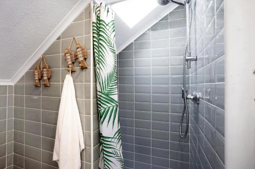 a bathroom with blue tiles and a shower at Casa River Sun in Valada
