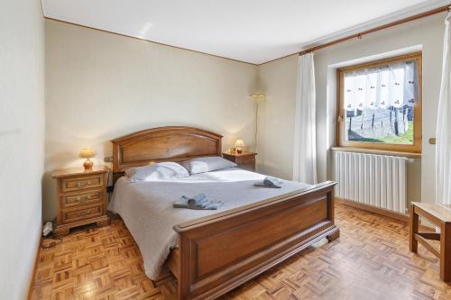 a bedroom with a large bed and a window at Baita Del Canton in Valdidentro