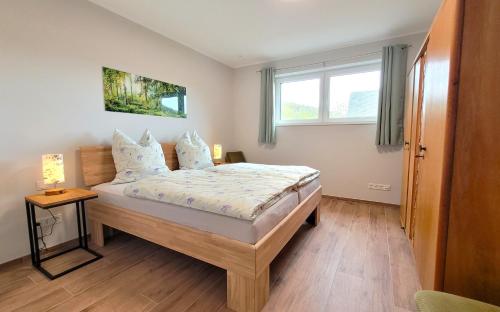 a bedroom with a bed and a window at Gittas Paradiesperle in Niederdreisbach