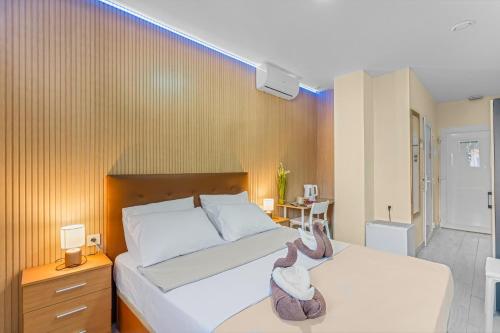 a bedroom with two white beds and a room with at 7A Hostal in Torrevieja