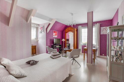 a bedroom with a white bed and purple walls at Chambre d'hôtes - Mon Plaisir in Civray-de-Touraine