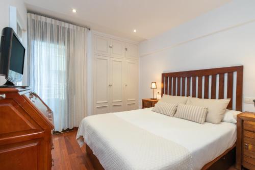 a bedroom with a bed and a flat screen tv at Maria Beach in Platja d'Aro