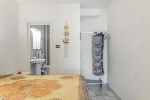 a white room with a bed and a bathroom at Syrios Suites No 2 in Kalymnos