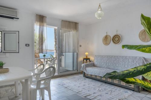 a living room with a couch and a table at Syrios Suites No 2 in Kalymnos