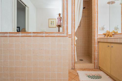 a bathroom with a shower and a mirror at Bella Vista Marinella 1 in Olbia