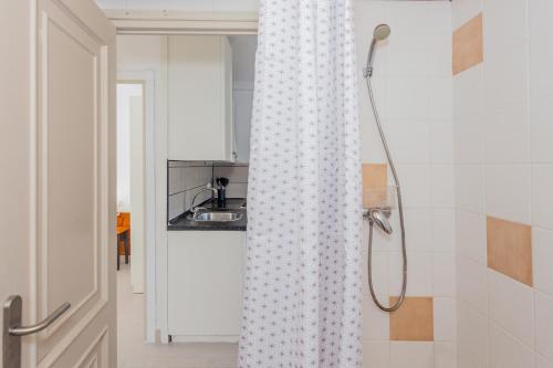 a shower curtain in a bathroom with a sink at Marlena in Cala en Bosc
