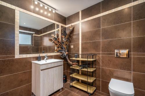 a bathroom with a toilet and a sink and a mirror at Quinta Dos 4 Ventos in Silves