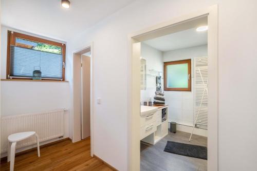 a white bathroom with a sink and a mirror at Ferienwohnung s'Raubers in Bühlertal