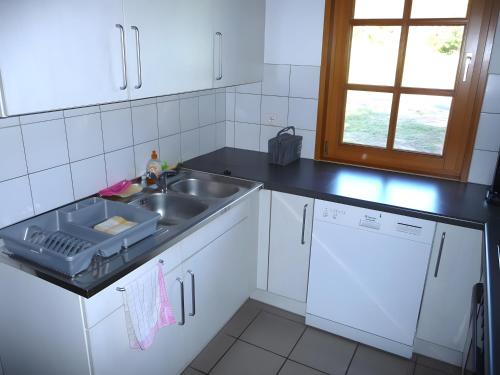 a kitchen with a sink and a counter top at Maison Sulz in Montendre