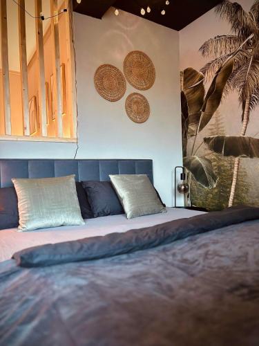 a bedroom with a large bed with pillows on it at Apartment Kokorey in Halstenbek