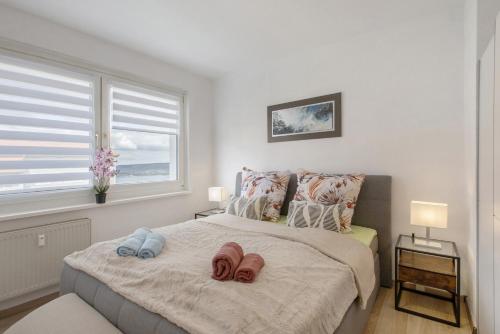 a bedroom with a bed with two slippers on it at Ferienwohnung San Marino 3 in Mücheln