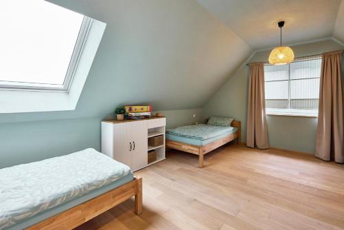 a bedroom with two beds and a window at Haus Auergang Schmallenberg in Schmallenberg