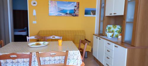 a dining room with a table with a plate on it at Villetta Lucy in Salve