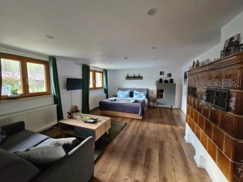 a living room with a couch and a table at Ferienwohnung Vordere Halde in Elzach
