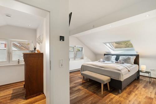 a bedroom with a bed and a table and windows at Forest Apartment - Renchen in Renchen