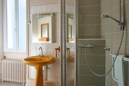 a bathroom with a sink and a glass shower at Villa Rosella in Les Sables-d'Olonne