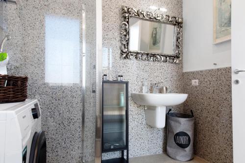 a bathroom with a sink and a mirror at Residenza La Fonte Dependance in Laveno-Mombello