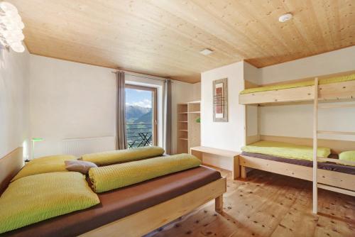 a bedroom with two bunk beds and a window at Joshof Bergblick in Moso