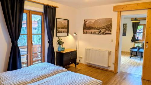a bedroom with a bed and a window at Ferienwohnungen St Christoph in Mittenwald