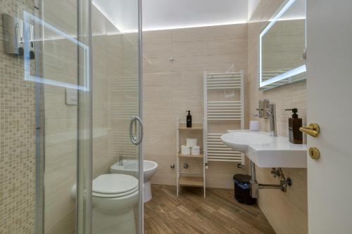 a bathroom with a toilet and a sink and a shower at Sant'Oronzo House in Lecce