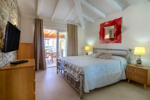 a bedroom with a bed and a mirror and a tv at Villa Flora Sea View in Cuile Pazzoni