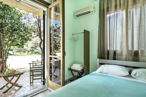 a bedroom with a blue bed and a mirror at Old Boat double studio 1 in Nikiana