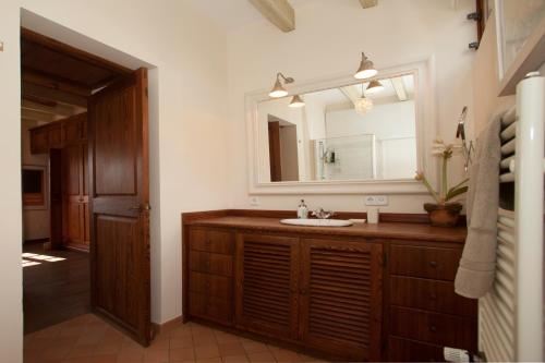 a bathroom with a sink and a mirror at Charming villa by the sea in Llucmajor