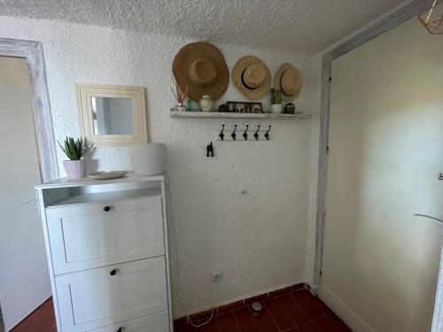 a room with white cabinets and hats on the wall at Villa Mediterraneo in Tossa de Mar
