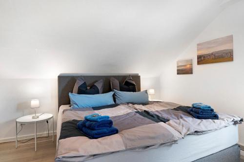 a bedroom with a bed with blue pillows on it at Zur Stadtmama in Endingen