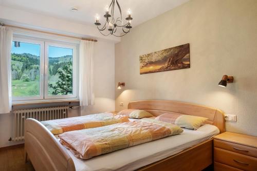a bedroom with a bed and a window at Aufblühen in Menzenschwand in St. Blasien