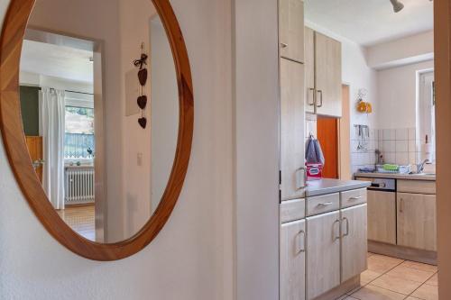 a kitchen with a large mirror on the wall at Aufblühen in Menzenschwand in St. Blasien