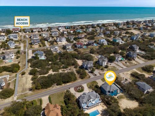 an aerial view of a suburb with a beach access sign at 1345 - Amarissa by the Sea in Corolla